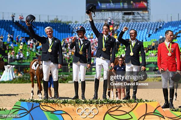 Gold medalists Roger Yves Bost of France riding Sydney Une Prince, Penelope Leprevost of France riding Flora de Mariposa, Kevin Staut of France...