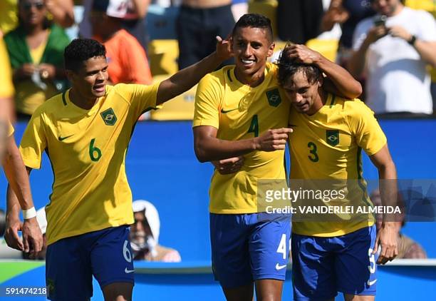 Marquinhos of Brazil celebrates with teammates Rodrigo Caio and Douglas Santos after scoring the 4th goal against Honduras during their Rio 2016...