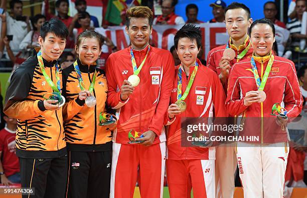 Gold medalists Indonesia's Tontowi Ahmad and Indonesia's Liliyana Natsir pose for a picture with Silver medalists Malaysia's Liu Ying Goh and...