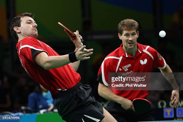 Bastian Steger and Timo Boll of Germany in action in the doubles match during the Men's Team Bronze Medal match between Korea and Germany at the Rio...