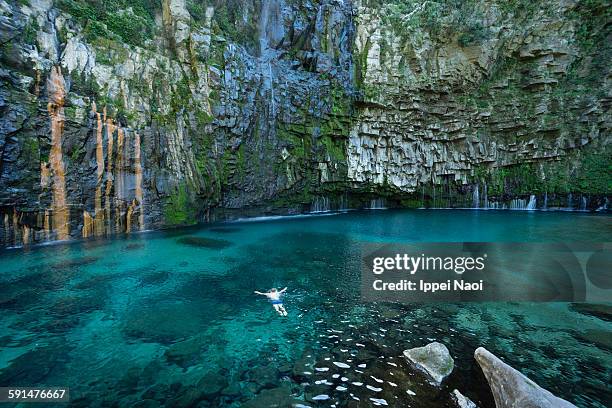 man swimming in waterfall lagoon, kagoshima, japan - kagoshima prefecture fotografías e imágenes de stock