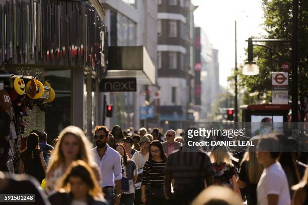 Pedestrians throng the busy Oxford street in central London on August 17, 2016. - From computers and cars to carpets and food, Britain's decision to...