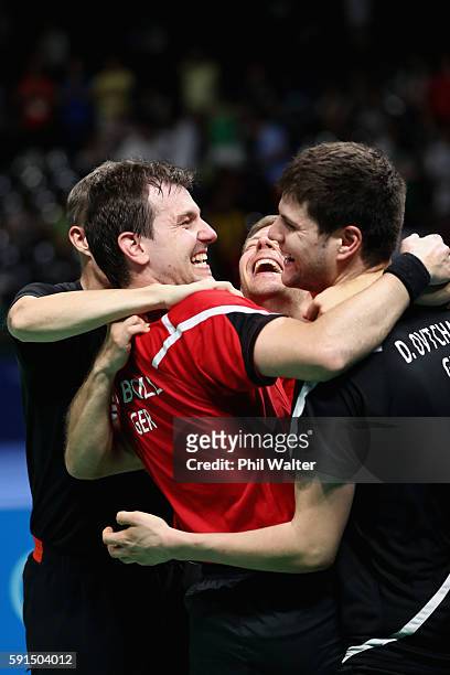 Timo Boll, Bastian Steger and Dimitrij Ovtcharov of Germany celebrate the Bronze Medal during the Men's Team Bronze Medal match between Korea and...