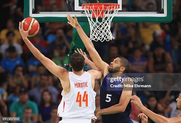 Nikola Mirotic of Spain goes to the basket against Nicolas Batum of France during the Men's Quarterfinal match on Day 12 of the Rio 2016 Olympic...