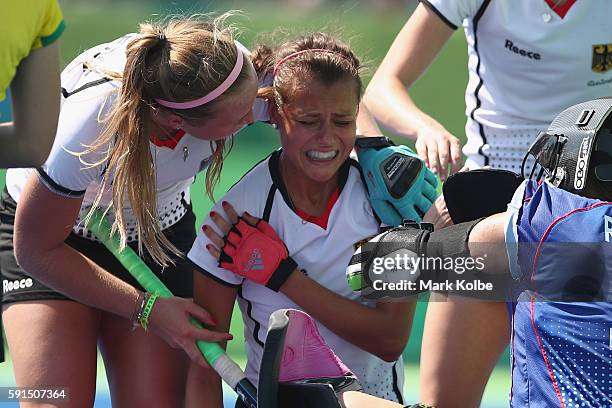 Selin Oruz of Germany holds her shoulder after being struck during the womens semifinal match between the Netherlands and Germany on Day 12 of the...