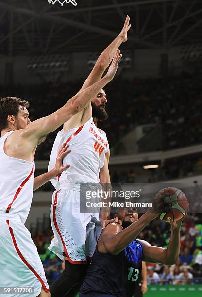 Pau Gasol and Nikola Mirotic of Spain defend against Boris Diaw of France during the Men's Quarterfinal match on Day 12 of the Rio 2016 Olympic Games...