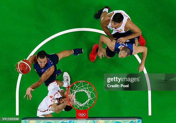 Joffrey Lauvergne of France goes to the basket against Felipe Reyes of Spain during the Men's Quarterfinal match on Day 12 of the Rio 2016 Olympic...