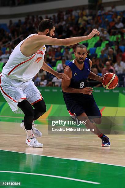 Tony Parker of France drives against Nikola Mirotic of Spain during the Men's Quarterfinal match on Day 12 of the Rio 2016 Olympic Games at Carioca...