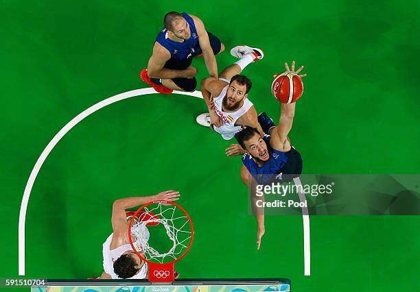 Joffrey Lauvergne of France goes for the rebound against Sergio Rodriguez of Spain during the Men's Quarterfinal match on Day 12 of the Rio 2016...