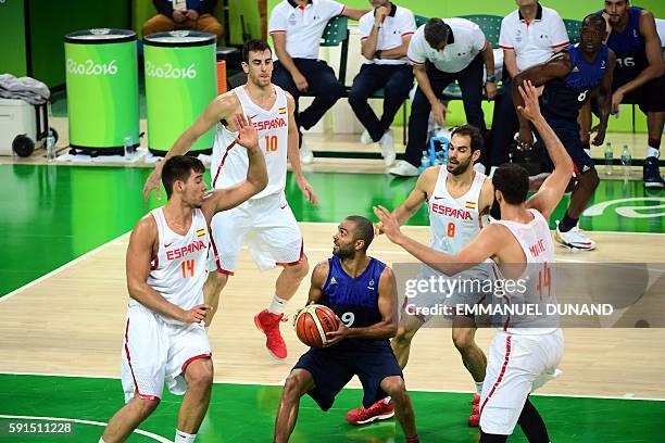 France's point guard Tony Parker is cornered by Spain's centre Willy Hernangomez, Spain's small forward Victor Claver, Spain's point guard Jose...