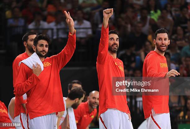 Ricky Rubio, Juan-Carlos Navarro and Rudy Fernandez of Spain celebrate on the bench during the Men's Quarterfinal match against France on Day 12 of...