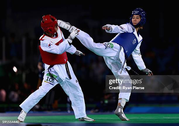 Sohui Kim of Korea competes against Panipak Wongpattanakit of Thailand during the Taekwondo Women's -49kg Quarter Final contest at Cairoca Arena 3 on...