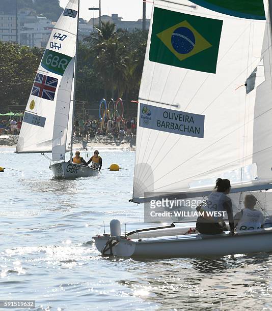 Britain's Hannah Mills and Saskia Clark and Brazil's Fernanda Oliveira and Ana Luiza Barbachan wait for the wind to compete in the 470 Women medal...