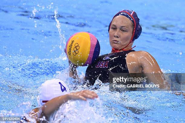 S Courtney Mathewson vies with Hungary's Hanna Kisteleki during their Rio 2016 Olympic Games water polo semifinal game at the Olympic Aquatics...