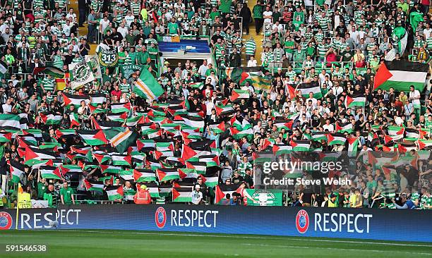 Palestinian flags are waved by fans during the UEFA Champions League Play-off First leg match between Celtic and Hapoel Beer-Sheva at Celtic Park on...