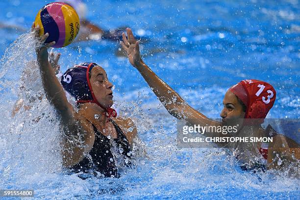 S Maggie Steffens is marked by Hungary's Orsolya Kaso during their Rio 2016 Olympic Games women's water polo semifinal game at the Olympic Aquatics...