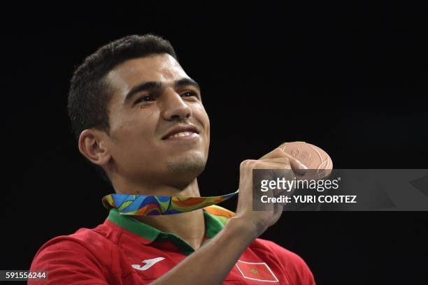 Morocco's Mohammed Rabii poses on the podium with a bronze medal after the Men's Welter Final Bout match at the Rio 2016 Olympic Games in Rio de...