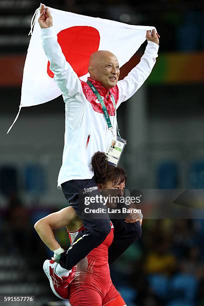 Eri Tosaka of Japan celebrates winning gold with coach Kazuhito Sakai over Mariya Stadnik of Azerbaijan in the Women's Freestyle 48kg event on Day 12...