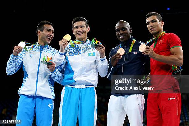 Shakhram Giyasov of Uzbekistan poses with the silver, Daniyar Yeleussinov of Kazakhstan with the gold, Souleymane Cissokho of France and Mohammed...