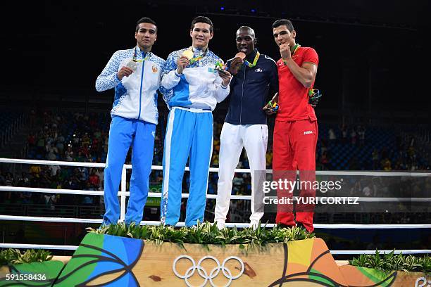 Uzbekistan's Shakhram Giyasov, Kazakhstan's Daniyar Yeleussinov, France's Souleymane Diop Cissokho and Morocco's Mohammed Rabii pose on the podium...