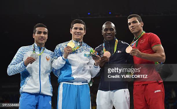 Uzbekistan's Shakhram Giyasov, Kazakhstan's Daniyar Yeleussinov, France's Souleymane Diop Cissokho and Morocco's Mohammed Rabii pose on the podium...