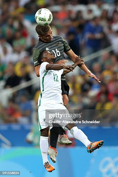 Stanley Amuzie of Nigeria and Grischa Proemel of Germany compete for the ball during the Men's Semifinal Football match between Nigeria and Germany...
