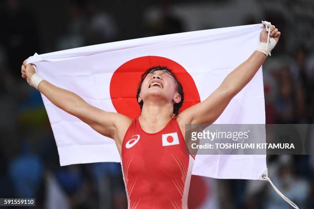 Japan's Eri Tosaka celebrates after winning against Azerbaijan's Mariya Stadnyk in their women's 48kg freestyle final match on August 17 during the...