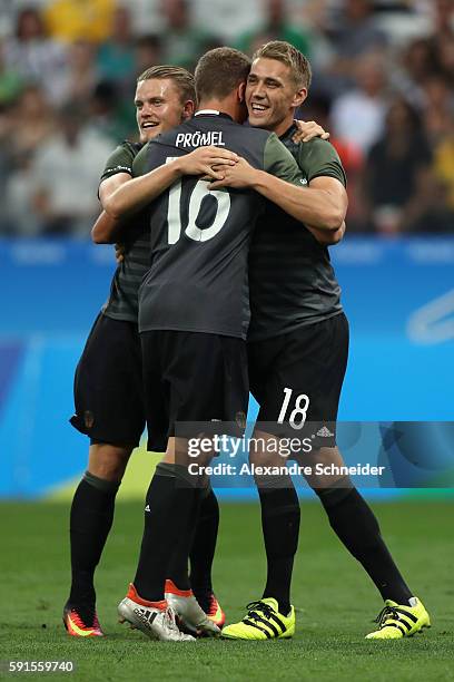 Nils Petersen of Germany celebrates scoring a goal with team mates Philipp Max and Grischa Proemel of Germany during the Men's Semifinal Football...