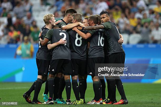 Nils Petersen of Germany celebrates scoring a goal with team mates during the Men's Semifinal Football match between Nigeria and Germany on Day 12 of...