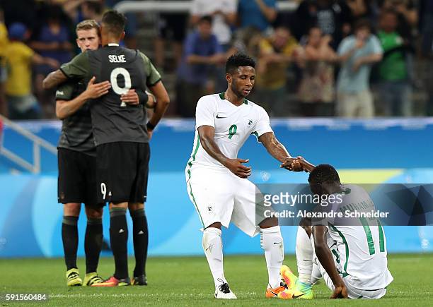Imoh Ezekiel of Nigeria and Usman Muhammed of Nigeria embrace after losing the Men's Semifinal Football match between Nigeria and Germany on Day 12...