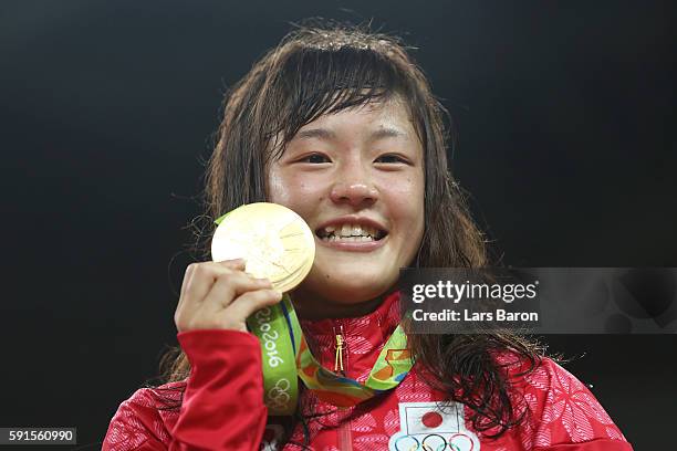 Gold medalist Eri Tosaka of Japan celebrates on the podium during the medal cermony for the Women's Freestyle 48kg event on Day 12 of the Rio 2016...