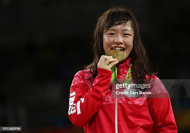 Gold medalist Eri Tosaka of Japan celebrates on the podium during the medal cermony for the Women's Freestyle 48kg event on Day 12 of the Rio 2016...