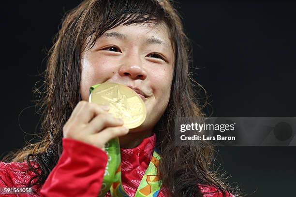 Gold medalist Eri Tosaka of Japan celebrates on the podium during the medal cermony for the Women's Freestyle 48kg event on Day 12 of the Rio 2016...