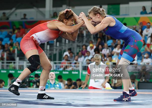 Tunisia's Marwa Amri wrestles with Azerbaijan's Yuliya Ratkevich in their women's 58kg freestyle bronze medal match on August 17 during the wrestling...