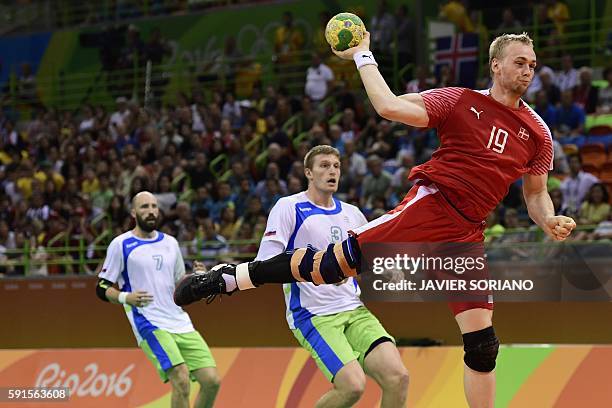 Denmark's pivot Rene Toft Hansen (R0 jumps to shoot during the men's quarterfinal handball match Denmark vs Slovenia for the Rio 2016 Olympics Games...