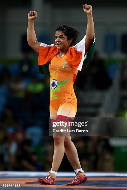 Sakshi Malik of India celebrates after defeating Aisuluu Tynybekova of Kyrgyzstan during the Women's Freestyle 58 kg Bronze match on Day 12 of the...