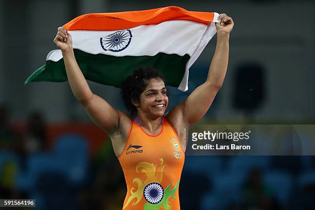 Sakshi Malik of India celebrates after defeating Aisuluu Tynybekova of Kyrgyzstan during the Women's Freestyle 58 kg Bronze match on Day 12 of the...