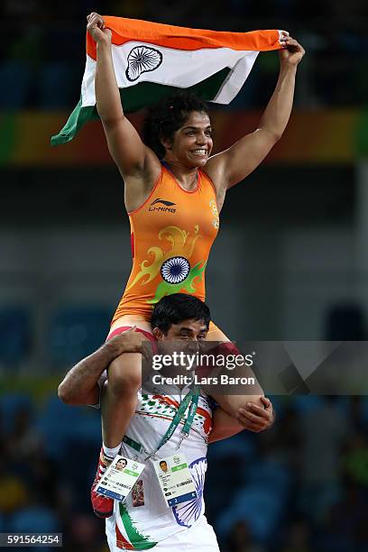 Sakshi Malik of India celebrates after defeating Aisuluu Tynybekova of Kyrgyzstan during the Women's Freestyle 58 kg Bronze match on Day 12 of the...