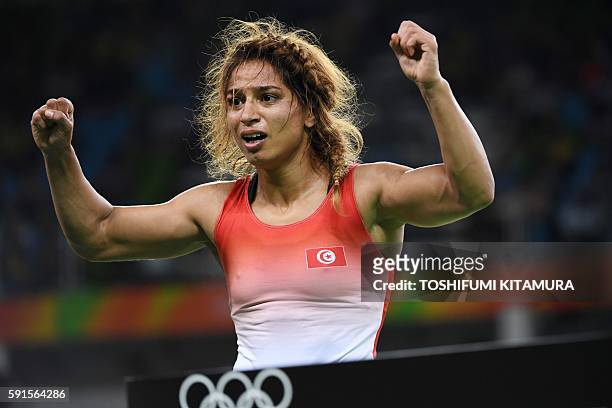 Tunisia's Marwa Amri celebrates after winning against Azerbaijan's Yuliya Ratkevich in their women's 58kg freestyle bronze medal match on August 17...