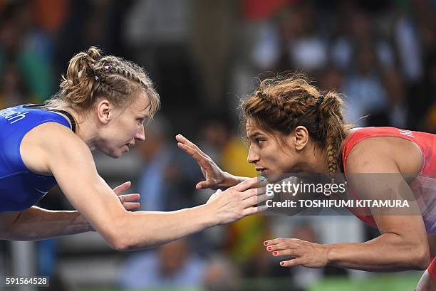 Tunisia's Marwa Amri wrestles with Azerbaijan's Yuliya Ratkevich in their women's 58kg freestyle bronze medal match on August 17 during the wrestling...