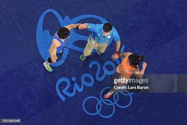 Sakshi Malik of India is declared the winner against Aisuluu Tynybekova of Kyrgyzstan during the Women's Freestyle 58 kg Bronze match on Day 12 of...