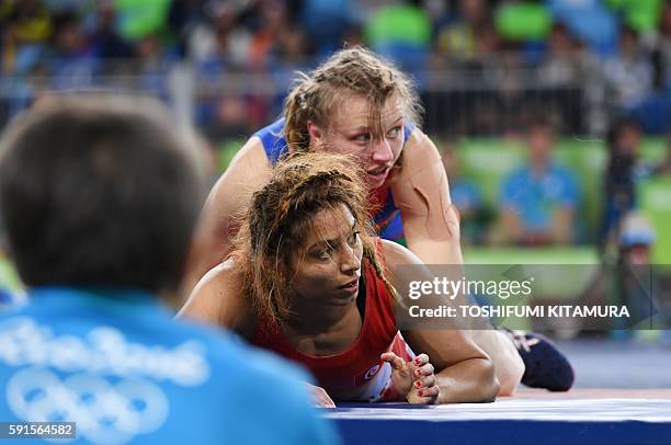 Tunisia's Marwa Amri wrestles with Azerbaijan's Yuliya Ratkevich in their women's 58kg freestyle bronze medal match on August 17 during the wrestling...