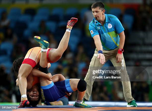 Sakshi Malik of India competes against Aisuluu Tynybekova of Kyrgyzstan during the Women's Freestyle 58 kg Bronze match on Day 12 of the Rio 2016...