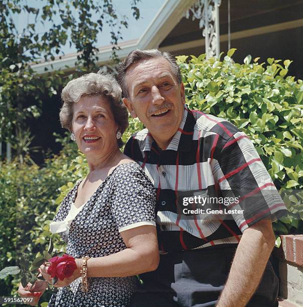 Portrait of American movie producer, artist, and animator Walt Disney and his wife, Lillian , as they pose outdoors, 1950s.