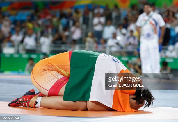 India's Sakshi Malik celebrates after winning against Kirghyzstan's Aisuluu Tynybekova in their women's 58kg freestyle bronze medal match on August...