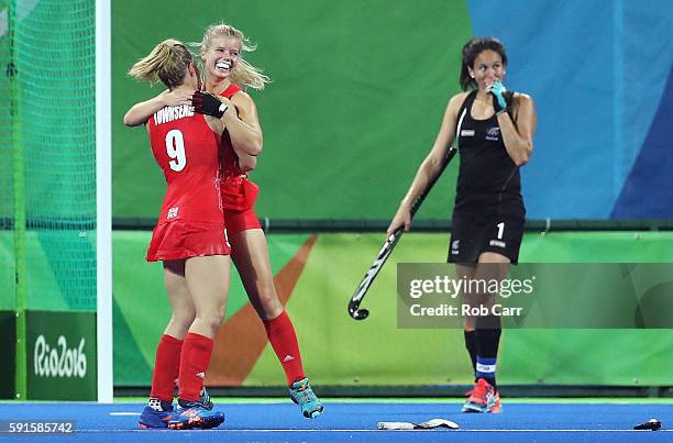 Sophie Bray of Great Britain and Susannah Townsend of Great Britain celebrate victory after the Women's Semifinal match between New Zealand and Great...