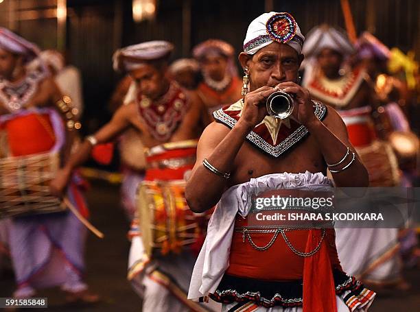 Sri Lanka's traditional dancers play traditional music and perform in front of the historic Buddhist Temple of the Tooth, as they take part in a...