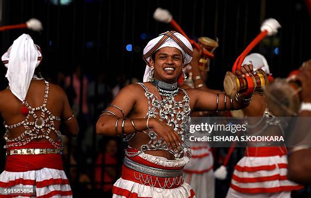 Sri Lanka's traditional dancers play traditional music and perform in front of the historic Buddhist Temple of the Tooth, as they take part in a...