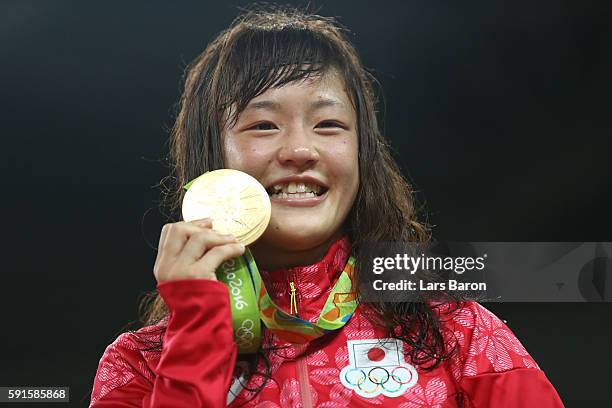 Gold medalist Eri Tosaka of Japan celebrates on the podium during the medal cermony for the Women's Freestyle 48kg event on Day 12 of the Rio 2016...