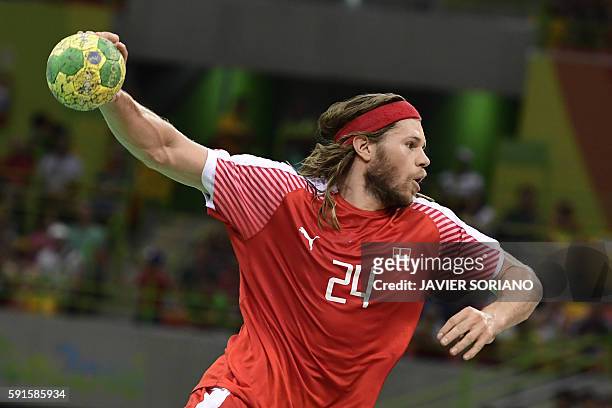 Denmark's left back Mikkel Hansen jumps to shoot during the men's quarterfinal handball match Denmark vs Slovenia for the Rio 2016 Olympics Games at...